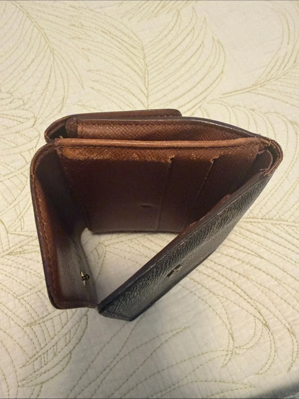 Louis Vuitton trifold snap wallet. Authentication provided.